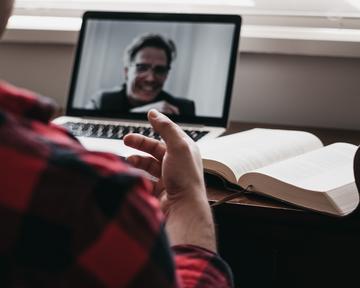 Someone having a meeting online with a laptop