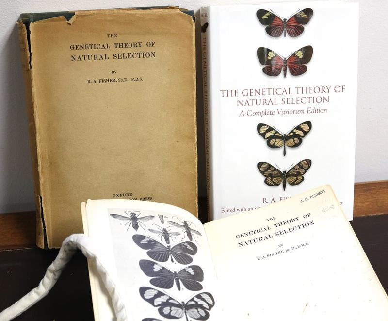 Three editions of The Genetical Theory of Natural Selection, published in 1930 (top-left), 1958 (bottom, open), and 1999 (top-right).