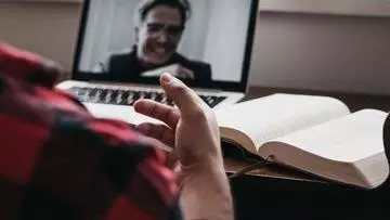 Someone having a meeting online with a laptop