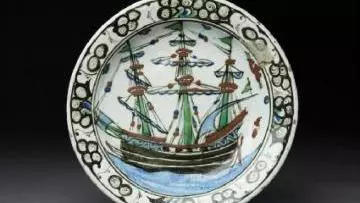 A plate with a painting of a ship